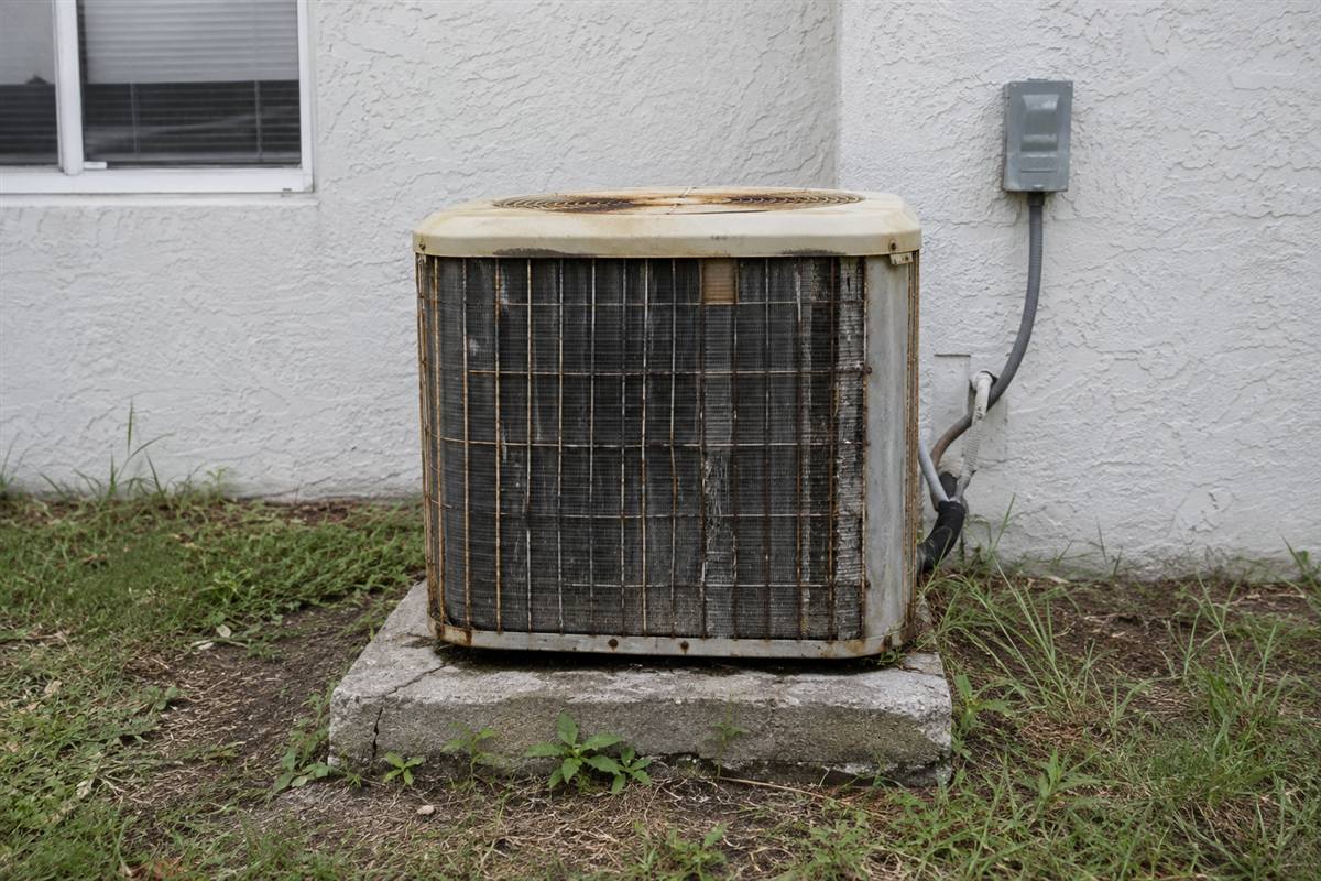 Old rusted air conditioner before replacement in Jacksonville