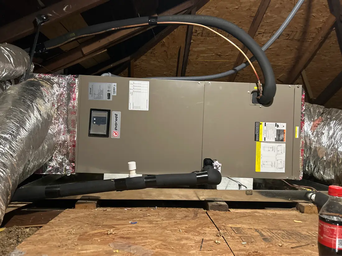 An air handler installed on a platform in an attic, with insulated flex ducts, on a Great Dane job